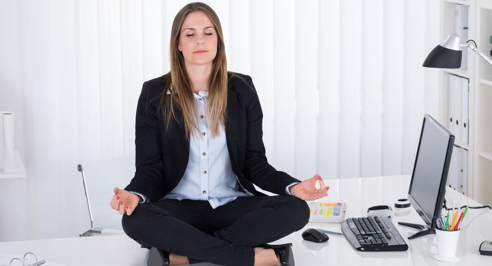 Businesswoman Doing Yoga In Office