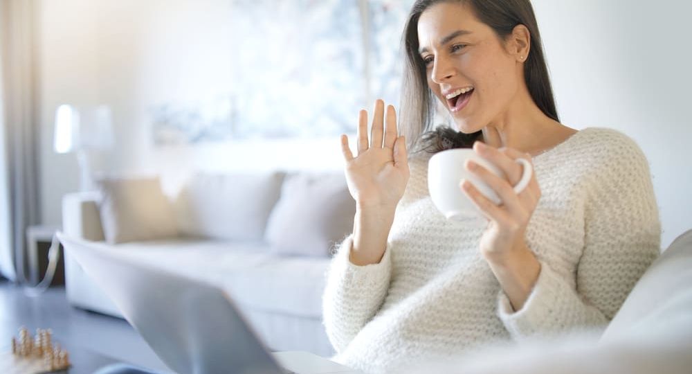 Relaxed beautiful brunette with laptop at home