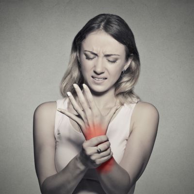 woman holding her painful wrist