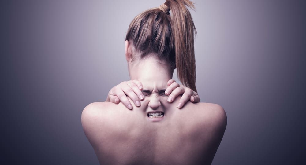 back of a woman indicating neck pain