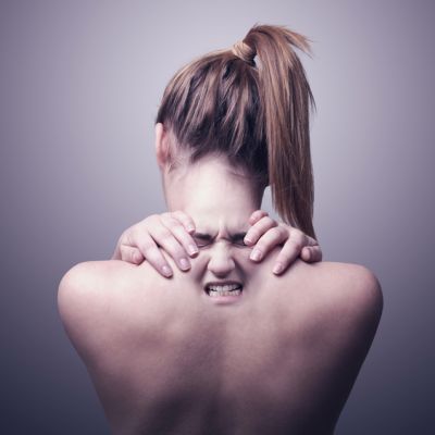 back of a woman indicating neck pain