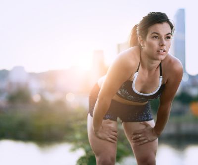 Portrait,Of,Active,Millenial,Woman,Jogging,At,Dusk,With,An